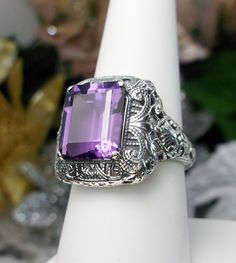 Natural Purple Amethyst Ring Intricate Design#149 Custom Made Inspired by Victorian era designs, I now offer this lovely filigree reproduction in sterling silver. This is a flawless natural purple amethyst is 12mm by 10mm in Length & Width. The ring is 3/4th of an inch North/South on the finger. The inside of the band is etched 925. Notice the intricate and detailed Victorian design of the antique patina silver filigree setting all the way down the band. This is an exquisite rendition of an Purple Amethyst Ring With Intricate Design, Purple Hallmarked Art Deco Amethyst Ring, Purple Anniversary Rings With Intricate Design, Art Deco Purple Amethyst Ring, Fine Jewelry Amethyst Ring With Intricate Design For Anniversary, Fine Jewelry Amethyst Ring With Intricate Design For Wedding, Amethyst Rings With Intricate Design For Wedding, Intricate Design Amethyst Ring For Wedding, Classic Purple Gemstones For Wedding