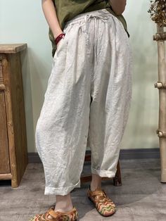 Stay cool and stylish in our Summer Solid 100% Linen Harem Pants. Crafted from breathable linen fabric, these pants offer a relaxed fit and effortless summer style. Perfect for casual outings or lounging at home, their versatile design ensures comfort without compromising on fashion. Neutral Cotton Bottoms For Vacation, Spring Summer Harem Pants With Pockets, Baggy Harem Pants For Beach And Spring, Beach Harem Pants With Pockets For Spring, Spring/summer Harem Pants With Pockets, Comfortable White Spring Pants, White Comfortable Pants For Spring, Comfortable White Pants For Spring, Summer Ankle-length Harem Pants With Pockets