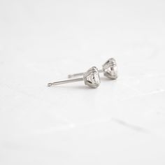 A pair of matching round brilliant cut diamonds in your choice of natural or lab-grown diamond. Please note: these earrings are listed with the total carat weight for both studs together. Each diamond is SI+ clarity, G+ color. Solid 14k gold posts and butterfly backings. Also available in platinum. Sold as a pair. We handcraft each piece with responsibly sourced metals and ethically sourced stones. Silver Single Diamond Earrings Fine Jewelry, White Gold Platinum Diamond Earrings With Single Diamond, Platinum White Gold Diamond Earrings With Single Diamond, Diamond White Solitaire Diamond Earrings, Solitaire Diamond White Diamond Earrings, Round Lab Grown Diamond Earrings With Diamond Cut, Diamond Cut Diamond Earrings, Fine Jewelry Diamond Cut Round Stone Earrings, Diamond Heart Cut Earrings With Prong Setting