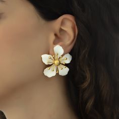 The magnolia flower meaning is attached with the symbols of nobility, perseverance, and love of nature. Soft and subtle in color yet strong in appearance, the flower is representative of the beauty encompassing femininity and gentleness. These earrings are handmade with 22K gold plated brass and enamel. These nickel free earrings are for pierced ears. They come as a pair with both butterfly and silicone earring backs. These beautiful earrings come with the Milou Jewelry box For avoiding damage t Elegant Flower Jewelry For Spring, Elegant Spring Flower Jewelry, White Classic Flower Earrings For Pierced Ears, Classic White Flower Earrings For Pierced Ears, Elegant Pierced Flower Earrings, White Classic Flower Earrings For Anniversary, Classic White Flower Earrings For Anniversary, White Classic Flower Earrings, Classic White Flower Earrings