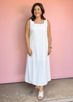 Get ready for summer with our Sea Worthy Linen Midi Dress! Effortlessly stylish with stripes and ric rac trim, this lightweight dress is perfect for vacations and beach days. Sun, sand, and style all in one piece! True to size Piper is wearing large Color: White with black pin stripes Stripe print square neck sleeveless midi dress featuring ric rac trim. Pocket at sides. Lined. Woven. Non-sheer. Lightweight. Fabric: 55%COTTON 35%LINEN 10%POLYESTER Fabric has no stretch Pull on design Summer White Dress With Vertical Stripes, Casual Vertical Stripes Maxi Dress For Beach, Beach White Maxi Dress With Vertical Stripes, White Summer Dress With Striped Hem, Casual Striped Maxi Dress For The Beach, Casual Maxi Dress With Vertical Stripes For The Beach, White Summer Dress With Vertical Stripes, Summer White Dresses With Vertical Stripes, Striped Summer Beach Dress