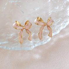 These adorable bow stud earrings are the perfect accessory for adding a touch of elegance and femininity to any outfit. Crafted from durable alloy with stainless steel ear needles, these earrings are designed for both style and comfort. The delicate bow shape with an enamel finish and gold-toned details adds a chic, whimsical touch to your jewelry collection. Whether you're dressing up for a special occasion or adding a cute accent to your everyday look, these lightweight earrings are a versatil Ribbon Earrings, Women Stud Earrings, Preppy Jewelry, Knot Stud Earrings, Knot Studs, Earrings Trendy, Bow Ribbon, Jewelry Accessories Ideas, Bow Jewelry