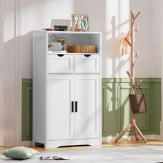 a white cabinet sitting in the corner of a room