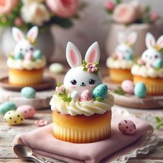 some cupcakes with bunnies and bunny ears on them sitting on a table