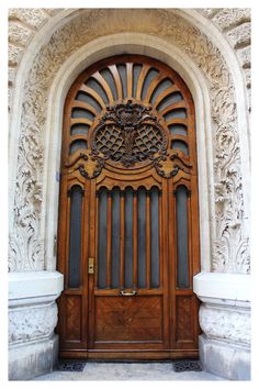 an ornate wooden door on the side of a building