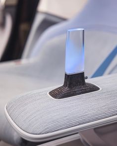 an electronic device is sitting on top of the seat in front of a couch or chair