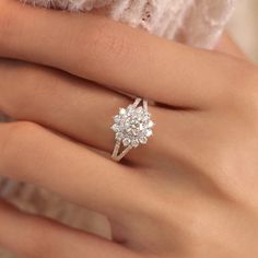 a woman's hand with a diamond ring on it