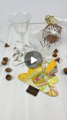 several glass objects are scattered on a white table