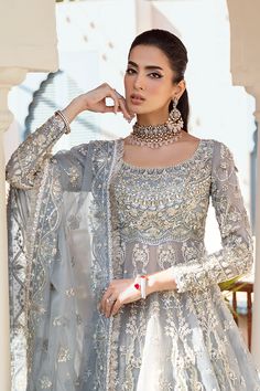 Bridal Gown Lehenga and Dupatta Pakistani Wedding Dress is an embellished masterpiece that will give the gorgeous bride a head-turning flawless look on the most important day of her life. Lavish designs and premium quality fabric make this Lehenga Dress an epitome of beauty. Pakistani Bridal Gown: Pakistani Bridal Gown has an alluring blue grey shade and is beautifully adorned with shimmering embellishments. Resham, dabka, crystals, sequins, and pearls enhance the glamour of this Pakistani Bridal Outfit. The Gown is fully embellished with intricate designs and silverwork. Bridal Lehenga: Pakistani Bridal Gown is paired with a huge flared Lehenga. Ruffles around the borders and premium organza give a perfect finishing to this gorgeous Lehenga. Ruffles enhance the charm and give a head-turni Semi-stitched Embellished Sharara For Wedding, Anarkali Style Embellished Wedding Dress For Eid, Anarkali Hand Embellished Organza Wedding Dress, Hand Embellished Floor-length Wedding Dress For Reception, Intricate Embroidered Floor-length Wedding Dress For Reception, Intricately Embroidered Floor-length Wedding Dress For Reception, Intricate Embroidery Floor-length Wedding Dress For Reception, Floor-length Wedding Dress With Intricate Embroidery For Reception, Festive Hand Embellished Wedding Dress