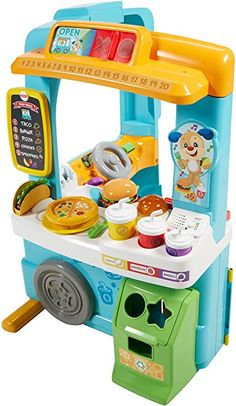 a toy kitchen playset with lots of food