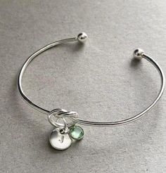 Pretty silver initial August birthstone bracelet bangle - an ideal personalised gift for a loved one or would make a lovely personalised gift for a Bridesmaid. A gift note can be added (any text can be written) just remember to add the note in the 'personalisation box'. + Bangle is adjustable so will fit most girls and women (to tighten the bangle gently squeeze it to make it smaller) + Silver plated bangle + Silver plated initial charm + Silver plated birthstone charm + Disc initial charm measure 10mm + Birthstone charm measures  6mm + Bracelet will come complete with a white gift box and organza pouch. Silver Knot Bracelet, Bangle Silver, Organza Pouch, Birthstone Bracelet, August Birthstone, Knot Bracelet, Birthstone Bracelets, Initial Bracelet, White Gift Boxes