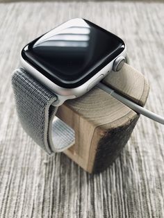 an apple watch is connected to a wooden block