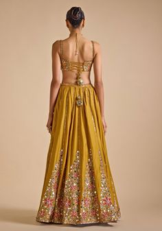 Transform your festive wardrobe with our Mustard Yellow Embroidered Lehenga Set, designed to captivate. Crafted from luxurious blended tussar fabric, the lehenga features intricate sequin and mirror embroidery in stunning floral patterns. Paired with a matching embellished blouse and soft net embroidered dupatta. Ideal for making a statement at Haldi, Mehendi and Sangeet ceremonies or as a standout wedding guest outfit. Composition : Blouse and Lehenga - Blended Tussar, Dupatta - Net Care: Dry C Traditional Drape Palazzo Set With Sequins For Diwali, Traditional Sequined Palazzo Saree Set, Diwali Floor-length Palazzo Set With Mirror Work, Festive Embroidered Sharara For Reception, Embellished Chanderi Sharara For Navratri, Anarkali Palazzo Set With Sequins For Festivals, Anarkali Style Sequined Palazzo Set For Festivals, Navratri Embellished Chanderi Sharara, Floor-length Sets With Intricate Embroidery For Navratri