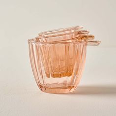 an empty glass cup sitting on top of a white table