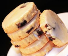 a white plate topped with cookies covered in frosting