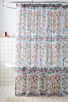 the shower curtain is decorated with colorful designs