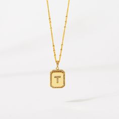 Timeless, elegant, and classy - our gold initial pendant necklace gives a personal touch to any outfit. This 18-20" personalized necklace features a gold pendant with an initial that is framed by shimmering crystals and the empowering message “I am Beautiful, Resilient, Strong, Enough, Loved ”is delicately engraved on the back. Tough days don't stand a chance against your inner fire! Wear this gold initial necklace to remind yourself that you are beautiful, loved, enough, strong, and resilient t Tan Monogram Initial Pendant Necklace, Tan Initial Pendant Necklace, Gold Monogram Initial Pendant Necklace, Gold Initial Necklace With Letter Beads For Anniversary, Gold Initial Necklace With Rectangular Pendant, Gold Tarnish Resistant Initial Necklace With Rectangular Pendant, Tan Initial Pendant Charm Necklaces, Classic Tan Initial Pendant Necklace, Elegant Gold Letter Bead Necklaces