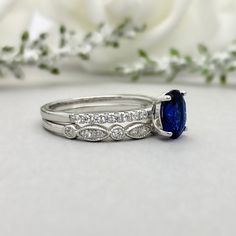 This beautiful ring is made from genuine 925 sterling silver with rhodium plating. Ring details- -The Main stone is an oval cut 8mm by 6mm Lab Created Blue Sapphire Stone -Side stones are 1.2 Round simulated diamonds -Ring is casted in solid 925 sterling silver with rhodium plating (yellow gold and rose gold plated also available, please check the drop down menu for more options) -The Total face height of the ring measures 8mms and the band width measures 2mms -Each ring is handmade and made to Oval Cubic Zirconia Stackable Rings, Oval Cubic Zirconia Stackable Rings With Prong Setting, Oval Sapphire Ring For Promise, Oval Sterling Silver Wedding Ring With Accent Stones, Oval Stackable Rings In White Gold And Sterling Silver, Blue Oval Stackable Rings For Anniversary, Formal Oval Stackable Cubic Zirconia Rings, Formal Oval Cubic Zirconia Stackable Rings, Formal Oval Stackable Rings With Cubic Zirconia