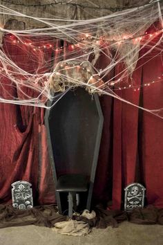 an old piano is covered with spiderweaves and lights in front of red drapes