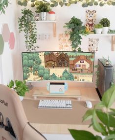 a desk with a keyboard, mouse and monitor on it in front of some plants