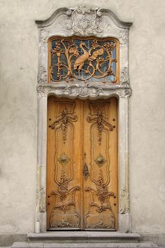 an ornate wooden door with carvings on it