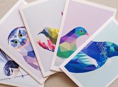 four cards with colorful birds on them sitting next to each other in front of a wall