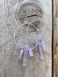 Raw purple quartz crystal points in gold or silver hoop earrings with French hooks. Perfect little boho look. Light weight and easy to wear. Add these to your boho outfits and make a 💜Healing clear quartz Crystal property has been know for centuries to restore balance in the body. -Options- 30mm as shown 21 gauge hoops Total drop Length: 2.3 inches 14k Gold filled hoops Sterling silver hoops Gold plated hoops Silver plated hoops All comes with hooks Simple, Dainty, Delicate, yet so Elegant and Wire Wrapped Amethyst Drop Earrings, Spiritual Hoop Earrings With Ear Wire, Purple Amethyst Hoop Jewelry, Everyday Purple Jewelry With Ear Wire, Adjustable Gemstone Hoop Jewelry, Adjustable Hoop Earrings With Spiritual Style, Adjustable Hoop Spiritual Earrings, Adjustable Spiritual Hoop Earrings, Nickel-free Purple Hoop Earrings