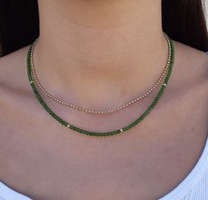 Green jade gemstone beaded necklace Made with smooth 4mm jade beads and 14k solid yellow gold beads and clasp. Please select your prefered length before checkout This minimalist necklace can be worn short as a chocker or longer alone or layered with other necklaces  **Please note the necklace on the model is 3mm.the necklace You will get is 4mm. Measures: 4mm  jade smooth beads 4 solid gold beads 2.5mm  6mm spring ring clasp 100% 14k solid gold hallmarked on clasp *if you prefer a fish lock clasp please convo me :) Runway Jewelry, Jade Bead Necklace, Dangle Earrings Wedding, Green Beaded Necklace, Beaded Necklace Designs, Pearl Earrings Wedding, Chocker Necklace, Jade Gemstone, Gemstone Beaded Necklace