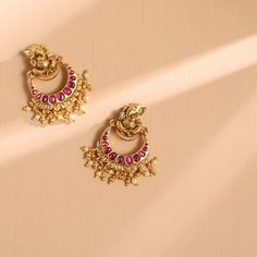 Description Spark your traditional style with these beautiful silver earrings from Paksha. Featuring a nakshi Lord Ganesha motif on the stud with a Kempu studded Chaandbali drop. This pair is finished with gold-tone plating and little gold ball drops. Wear yours with other nakshi jewelry – these are true favorites. Product Information Materials used: 925 Silver with 1.0-microns Antique Gold Plating Stones: Semi precious stones Length: 4 cm Findings: Hook & links Temple Style Dangle Jhumkas, Temple Jewelry Chandbalis With Latkans, Temple Jewelry Style Chandbalis With Latkans, Elegant Meenakari Earrings For Puja, 22k Gold Temple Jewelry Bridal Earrings With Latkans, 22k Gold Meenakari Earrings For Navratri, Elegant Chandbali Earrings For Puja, Traditional Round Earrings For Puja, Elegant Earrings For Puja And Diwali