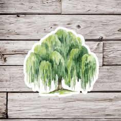 a watercolor painting of a tree with green leaves on the branches and wood planks