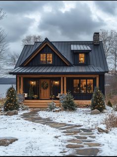 a house that has some lights on in the front and side of it with snow