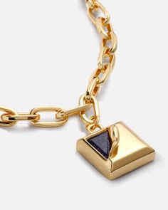 This ultra-modern square tag pendant features a stunning “pushing-the-boundaries” style sparkling with midnight blue crystals. A petite bail on the top connected to a rectangle cable chain necklace keeps this pendant centered, all in a bright shine. 
 
Length: 18.9in
Width: 7mm
Stone Color: Midnight Blue
Pendant Size: 17x17mm
Material: Starlight Quartz, 18k Gold Plated On Brass Modern Jewelry With Rectangular Pendant Box Chain, Modern Jewelry With Cable Chain And Rectangular Pendant, Modern Jewelry With Square Pendant Chain, Modern Jewelry With Rectangular Pendant On Cable Chain, Luxury Rectangular Pendant Jewelry With Cable Chain, Modern Jewelry With Rectangular Cable Chain, Modern Square Jewelry With Adjustable Chain, Square Pendant Necklace, Cable Chain Necklace