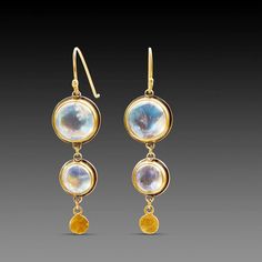 A pair of luminous moonstones are accented with a tiny 22k gold disk in each of these lovely earrings. Set in bezels of 22k gold, and backed with sterling silver. 18k gold earwires. Earrings hang approximately 1 1/2 inches. Matte finish. Gold Hand-forged Moonstone Earrings, Gold Hand Forged Moonstone Earrings, Gold Moonstone Hand Forged Earrings, Moonstone Round Yellow Gold Earrings, Round Moonstone Yellow Gold Earrings, Moonstone Yellow Gold Round Earrings, Yellow Gold Round Moonstone Earrings, Hand Forged Gold Moonstone Earrings, Round Gold Moonstone Earrings