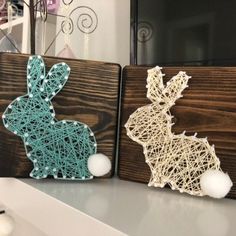 two bunny string art pieces are sitting on a shelf