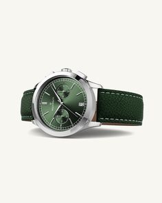 Case diameter: 39 mmCase thickness: 11.15 mmMaterial: Rhodium-plated 316L stainless steel Dial: Green sunray dial in brassIndex & hands: Polished stainless steelGlass: Sapphire CrystalMovement: Seiko VK64 HybridWater Resistance: 10 ATM (snorkeling)Strap: Genuine green leather, clasp in rhodium-plated stainless steelStrap size: Onesize, fits all wristsLug width: 20 mmPackaging: Black leather box with certificate and manualAvailability: In stock, Free and fast Shipping Worldwide Green Watch, Timeless Watches, Leather Box, Ring Watch, Silver Gifts, Green Leather, Watch Brands, Bracelet Gift, Leather Watch