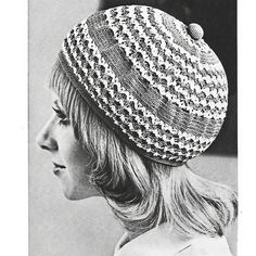 black and white photograph of a woman wearing a crocheted hat with buttons on it