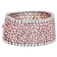 Indulge in the mesmerizing allure of this exquisite diamond bracelet, a testament to sophistication and artistry. Designed with a highly flexible band, it showcases a captivating array of radiant, oval, and pear-cut diamonds, each adorned with various Fancy Pink hues, totaling approximately 47 carats. The intricate arrangement of these pink diamonds is complemented by lines of round-cut near-colorless diamonds, totaling 8.16 carats, creating a harmonious blend of color and brilliance. The bracel Platinum Rose Gold, Modern Bracelets, Colorless Diamond, Expensive Jewelry, Rose Gold Bracelet, Rose Gold Metal, Pink Stone, Pink Diamond, Stone Bracelet