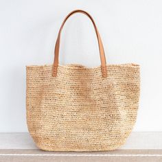 Chic large straw woven tote bag perfect for all occasions. This tote bag is sure to keep up with your busy lifestyle, providing a lightweight and durable design with a classic aesthetic. It’s the perfect way to stay organized while making a stylish statement. Natural Soft Raffia Straw Genuine leather handlesNo linerDimensions: 14"H x 20"W x 8.5"D10" handle drop Designer Style ID: 8583 Large Straw Woven Tote Bag, Summer Bag, Everyday Shoulder Bag, Beach Bag Everyday Summer Beach Bag With Rolled Handles, Summer Jute Bag With Rolled Handles, Casual Crochet Straw Bag With Rolled Handles, Everyday Natural Shoulder Bag With Rolled Handles, Everyday Straw Beach Bag With Rolled Handles, Everyday Summer Straw Bag With Double Handle, Summer Straw Bag With Double Handle For Everyday, Everyday Shoulder Beach Bag With Rolled Handles, Natural Straw Tote Bag