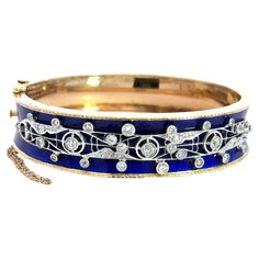 This Stunning Vintage Bangle Bracelet Dates from The 1940s. It’s Crafted in 14KT Yellow Gold with Beautiful Blue Enamel. The Enamel is in Excellent Condition. 1.35ct of Beautiful Old European Cut and Old Mine Cut Diamonds. F-H Color VS-SI Clarity. The Bracelet Fits Up To a 6.75 inch Wrist. The Bracelet Measures 15.5mm Wide and Tapers to 12.7mm. This bangle weighs 35.1 grams. Why we love it: We love the bright cobalt blue enamel next to the warmth of the yellow gold and the bezeled diamonds. This 1st Dibs, Vintage Bangle Bracelets, Vintage Bangles, Matching Ring, Matching Rings, Statement Bracelet, Beautiful Blue, Cobalt Blue, Bangle Bracelet