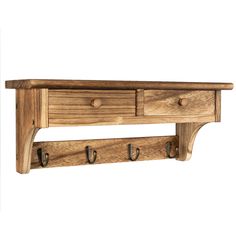 a wooden shelf with three hooks on it