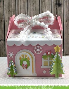 a pink and white box with snow decorations on it