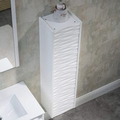 a bathroom with a sink, mirror and towel dispenser