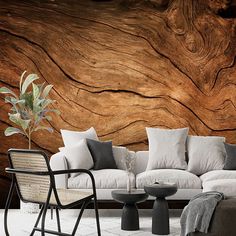 a living room filled with furniture next to a wooden wall