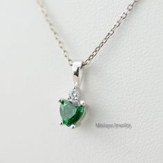 Captivating with its emerald green hue is the heart-shaped emerald in prong-setting. Emerald is May Birthstone. It is topped with a sparkling diamond (CZ) accent. This minimalist Emerald pendant is crafted in Sterling Silver (0.925). Perfect gift for Christmas, Valentine's Day, Mother's Day, Aniversary, and just for the sake of gifting. 🎀 Dimensions: Pendant height: 13 mm Pendant width: 6 mm Heart-cut Emerald width: 6 mm Heart-cut Emerald height: 5 mm 🎀 Please note that pictures are magnified Heart-shaped Emerald Necklace For Gift, Emerald Heart Charm Jewelry, Heart Cut Emerald Necklace For Gift, Heart-shaped Emerald Necklaces For Anniversary, Heart Shaped Emerald Necklace As A Gift, Heart-shaped Emerald Necklace As A Gift, Heart-shaped Emerald Necklaces As A Gift, Heart-shaped Green Emerald Necklace As Gift, Heart-shaped Emerald Necklace For Anniversary