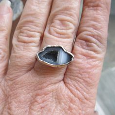 "Silver Mini Geode Ring Gray Druzy Ring Sparkly Druse Gemstone Ring: A stunning, one-of-a-kind, handmade stackable ring featuring a natural sparkling druzy geode set in sterling silver. The geode is gray and white and it measures 11/16\" by 7/16\". Band is 1/16\" wide. The ring itself is a size 6. Completely handmade by myself in sterling silver. Enter my shop: https://www.etsy.com/shop/artdi Join me on Facebook: https://www.facebook.com/Artdi-Diana-Anton-Jewelry-Design-44805607932/ Find me on I Artisan Rings With Natural Stones For Gift, Artisan Gemstone Promise Rings, Artisan Open Ring With Natural Stones, Adjustable Stackable Rings With Natural Stones, Toe Ring With Natural Stones For Gift, Minimalist Natural Stone Ring For Anniversary, Adjustable Stackable Rings With Stones, Spiritual Open Ring With Natural Stones, Spiritual Open Ring With Stones