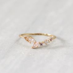 The Dove ring features clear and light blush pink marquise crystals in a V-shape, mixed with rose pink and lavender circle crystals. This dreamy ring adds the perfect colourful touch to your stacking look or outfit of the day. Main material: Rose Gold, Rhodium, 16k Gold Plated on Brass, Colourful Cubic Zirconia Need some jewelry inspiration? Follow us on Instagram  @statementGrey Dainty Pink Stackable Rings For Wedding, Feminine Rose Quartz Wedding Jewelry, Delicate Cubic Zirconia Crystal Ring, Pink Open Ring Midi Rings For Wedding, Pink Moonstone Promise Ring, Dainty Pink Crystal Ring For Wedding, Pink Dainty Birthstone Ring For Wedding, Delicate Rose Quartz Jewelry For Wedding, Delicate Rose Quartz Wedding Jewelry