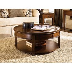 a living room with a coffee table on top of a carpeted floor next to a couch