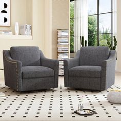 two gray chairs sitting on top of a black and white floor next to each other