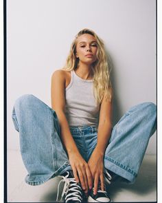 a woman sitting on the floor with her legs crossed