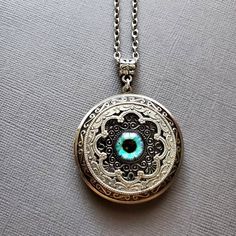 Large Locket Dragon Eye Necklace ☻Locket ~ Large, Decoratively Styled ~ Measures 1.77 inches round See Photos for size comparison against American quarter Chain: ~ Silver Plated YOU CHOOSE YOUR CHAIN LENGTH during checkout ☻More Lockets Here: https://www.etsy.com/shop/FashionCrashJewelry/search?search_query=lockets&order=date_desc&view_type=gallery&ref=shop_search ☻Link to The ENTIRE SHOP: https://www.etsy.com/shop/FashionCrashJewelry?ref=shopsection_shophome_leftnav&ga_search_qu Vintage Round Pendant Jewelry For Festivals, Antique Silver Spiritual Jewelry, Vintage Locket Jewelry For Festivals, Vintage Festival Locket Jewelry, Silver Jewelry With Vintage Charm For Festivals, Bohemian Engraved Round Locket Necklace, Bohemian Handmade Jewelry For Keepsake, Handmade Bohemian Keepsake Jewelry, Bohemian Handmade Keepsake Jewelry